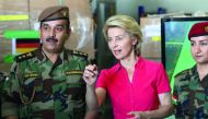 German Defence Minister Ursula von der Leyen (C) speaks to Kurdish Peshmerga fighters during her visit to the military camp of Mirra on the outskirts of Arbil, the capital of the northern Iraqi Kurdish autonomous region on September 17, 2018. AFP / Safin 