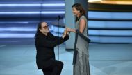 Glenn Weiss (L), winner of the Outstanding Directing for a Variety Special award for 'The Oscars,' proposes marriage to Jan Svendsen onstage during the 70th Emmy Awards at the Microsoft Theatre in Los Angeles, California on September 17, 2018. AFP / Robyn