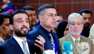 Mohammed al-Halbusi (L), newly elected speaker of the Iraqi Parliament, delivers a speech on September 18, 2018, following a meeting in Basra. AFP / Haidar Mohammed Ali
