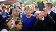 German Chancellor Angela Merkel, a top candidate of the Christian Democratic Union Party (CDU) for the upcoming general elections poses for a selfie during an election rally in Stralsund, Germany September 16, 2017. Reuters/Axel Schmidt