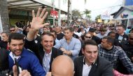 FILE PHOTO: Presidential candidate Jair Bolsonaro is greeted by supporters during an agribusiness fair in Esteio, Rio Grande do Sul state, Brazil August 29, 2018. REUTERS/Diego Vara/File photo