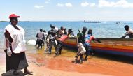 Rescuers push a boat to the water on Lake Victoria on September 22, 2018, during searches for victims a day after the ferry MV Nyerere capsized.   AFP / Casmir ODUOR