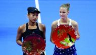 Karolina Pliskova (R) of Czech Republic, flanked by second-placed Naomi Osaka of Japan, poses with her victory trophy. Reuters/Toru Hanai 