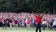 Tiger Woods of the United States celebrates making a par on the 18th green to win the TOUR Championship at East Lake Golf Club on September 23, 2018 in Atlanta, Georgia. Tim Bradbury/Getty Images/AFP / AFP / GETTY IMAGES NORTH AMERICA / Tim Bradbury