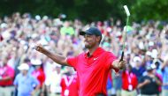 Tiger Woods of the United States celebrates making a par on the 18th green to win the Tour Championship at East Lake Golf Club on September 23, 2018 in Atlanta, Georgia. Tim Bradbury/Getty Images/AFP