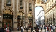 People stroll in front of Versace's flagship shop at Galleria Vittorio Emanuele II in Milan, Italy, September 25, 2018. Reuters/Stefano Rellandini