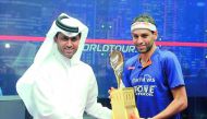 Nasser Ghanem Al Khelaifi, President of Qatar Tennis, Squash and Badminton Federation (QTSBF), handing over the Qatar Classic trophy to Mohamed El Shorbagy in this last November’s file photo.  