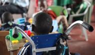 A child with cerebral palsy sits in wheelchair in an orphanage in eastern Nairobi, Kenya on Sept 26, 2018. Thomson Reuters Foundation/Nita Bhalla