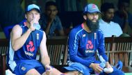 England cricketers Jos Buttler (L) and Moeen Ali take a break while watching other players during a practice session at the P. Sara Oval Cricket Stadium in Colombo on October 4, 2018.  AFP / Lakruwan Wanniarachchi