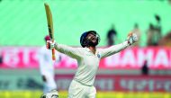 India's Ravindra Jadeja celebrates after reaching his century (100 runs) during the second day's play of the first Test cricket match between India and West Indies at the Saurashtra Cricket Association stadium in Rajkot on October 5, 2018. AFP / Indranil 
