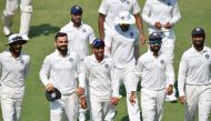 (front L-R) Indian cricketers Ravindra Jadeja, Virat Kohli, Kuldeep Yadav, Ajinkya Rahane and Cheteshwar Pujara walk back after winning the first Test cricket match between India and West Indies at the Saurashtra Cricket Association Stadium in Rajkot on O