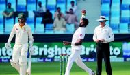 Pakistan cricketer Bilal Asif (C) bowls during the third day of play of the first Test cricket match in the series between Australia and Pakistan at the Dubai International Stadium on October 9, 2018. AFP / Karim Sahib

