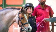 A couple of young riders wait for their turn at Al Shaqab Arena in Doha yesterday. Al Shaqab, one of the top equestrian venues around the world, will welcome the best riders for the final round of the Longines Global Champions Tour next month. 