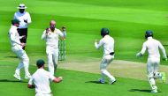 Australia cricketer Nathan Lyon (2nd L) celebrates after he dismissed Pakistan cricketer Asad Shafiq during day one of the second Test cricket match in the series between Australia and Pakistan at the Abu Dhabi Cricket Stadium in Abu Dhabi on October 16, 