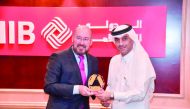 QIIB Deputy CEO, Jamal Abdulla Al Jamal (right) receiving the award from  Andreas Scheer, Head (Loan Capital Markets) FI Frankfurt.