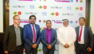 Ali Al Hitmi, Executive Director of the Organizing Committee for the 48th Artistic Gymnastics World Championships Doha 2018 poses for a picture, with the national suppliers and radio partner for the upcoming championship,  after signing agreements in Doha