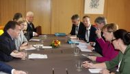 German Chancellor Angela Merkel (2R) meets with Russia's Prime Minister Dmitry Medvedev (L) during a meeting on the sidelines of an EU-ASEM leaders meeting at the European Council in Brussels on October 19, 2018. / AFP / POOL / Olivier Matthys