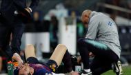 Barcelona's Lionel Messi receives medical attention after sustaining an injury REUTERS/Albert Gea