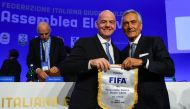 :New President of the Italian Football Federation (FIGC), Gabriele Gravina (R) poses with FIFA President, Gianni Infantino following the vote during the elective assembly of the FIGC on October 22, 2018 at the Hilton hotel of Rome's Fiumicino airport. / A