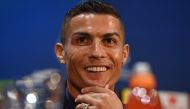 Juventus' Portuguese striker Cristiano Ronaldo smiles during a press conference at Old Trafford in Manchester, north west England on October 22, 2018, on the eve of their UEFA Champions League group H football match against Juventus on October 23. / AFP /