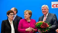 German Chancellor and leader of the Christian Democratic Union (CDU) Angela Merkel (C) stands with Secretary General of the Christian Democratic Union (CDU) Annegret Kramp-Karrenbauer (L) and Hesse's State Premier and Deputy Chairman of the Christian Demo