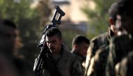 Fighters from the Syrian Democratic Forces (SDF) attend the funeral of one of their commanders, killed a day earlier in the town of Hajin during battles against the Islamic State (IS) group, in the Kurdish-controlled city of Qamishly in northeastern Syria