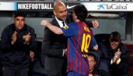 FILE PHOTO: Barcelona's Lionel Messi celebrates his fourth goal with coach Pep Guardiola against Espanyol during their Spanish first division soccer match at Nou Camp stadium in Barcelona May 5, 2012. REUTERS/Gustau Nacarino/File Photo