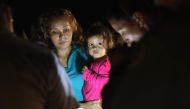 Central American asylum seekers including a Honduran girl aged 2 and her mother near the US-Mexico border in McAllen Texas on June 12, 2018. (AFP Getty Images North America / John Moore) 