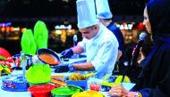 A chef preparing food at cooking show as part of the Taste Tour at Mall of Qatar. 