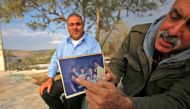 The uncle of Rashida Tlaib, the winner of Michigan's 13th congressional district in the 2018 US general election, displays a picture of her in the village of Bayt Or al Fawqa, in the occupied West Bank on November 8, 2018.  AFP / Abbas Momani 

 