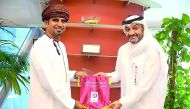 Qatar Stars League (QSL) CEO Hani Taleb Ballan presenting a souvenir to Oman Professional League (OPL) Director Hisham Al Adwani during their meeting yesterday. 