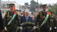 Palestinian President Mahmoud Abbas (C) lays a wreath at the Mausoleum of former Palestinian leader Yasser Arafat during a commemoration ceremony held for the 14th death of Yasser Arafat in Ramallah, West Bank on November 11, 2018. (Issam Rimawi/Anadolu A
