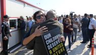 People hug each other at newly opened checkpoint linking the Greek and Turkish Cypriot communities in Dherinia, Cyprus November 12, 2018. REUTERS/Yiannis Kourtoglou