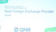 A QNB official with the award.