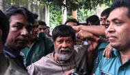  In this file photo taken on August 6, 2018 activist and photographer Shahidul Alam arrives surrounded by policemen for an appearance in court in Dhaka.  AFP / Munir Uz Zaman
 