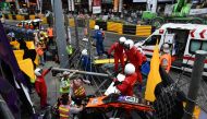 Race personnel and pit crew are seen at the accident site after Sophia Floersch, a German driver of Van Amersfoort Racing flew over the barriers and crashed into a photographers' bunker at high speed, during a Formula Three race at the Macau Grand Prix, i