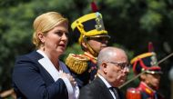 FILE PHOTO: President Kolinda Grabar-Kitarovic sings Croatia national anthem next to Argentine FM Jorge Faurie, during a wreath-laying ceremony to pay homage to Jose de San Martin in Buenos Aires. AFP/Eitan Abramovich