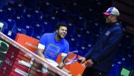 France's Jo-Wilfried Tsonga (L) shares a light moment with team captain Yannick Noah during a training session at The Pierre Mauroy Stadium in Villeneuve d'Ascq on November 21, 2018, ahead of the Davis Cup final tennis match that is scheduled to take plac