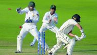 New Zealand batsman Neil Wagner (R) is bowled out as Pakistani captain and wicketkeeper Sarfraz Ahmed (L) and Asad Shafiq (C) look on during the third day of the first Test cricket match between Pakistan and New Zealand at the Sheikh Zayed International C