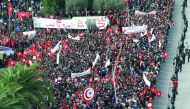 Tunisian civil servants and workers gather during a protest held for wage increase by Tunisian General Labour Union (UGTT) in Tunis, yesterday.