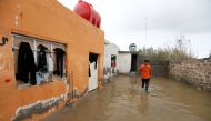 An Iraqi man cleans his house after heavy rainfall in al-Aziziyah, Iraq November 25, 2018. REUTERS/Khalid al-Mousily