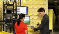 Canada Prime Minister Justin Trudeau scans merchandise with an employee during a tour of the Amazon Fulfillment Centre in Brampton, Ontario, Canada, October 20, 2016. Reuters/Fred Thornhill
