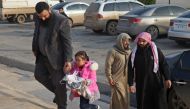 Members of the civilian branch of the powerful Hayat Tahrir al-Sham (HTS) alliance, which is led by the jihadists of Syria's former Al-Qaeda affiliate, escort four-year-old girl named Yasmine near the Bab al-Hawa crossing with Turkey on November 26, 2018.