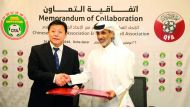 Qatar Football Association (QFA) President Sheikh Hamad bin Kahlifa bin Ahmed Al Thani and Du Zhaocai, Vice Sports Minister of China and CFA Acting President exchange documents during the signing ceremony in Doha yesterday.