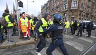 Demonstrators face riot police officers during a protest of Yellow vests (Gilets jaunes) against rising oil prices and living costs, in Strasbourg, eastern France, on December 1, 2018. / AFP / PATRICK HERTZOG