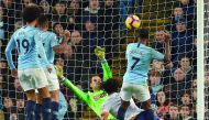Manchester City's English midfielder Raheem Sterling (R) scores their second goal for 2-1 past Bournemouth's Bosnian-Herzegovinian goalkeeper Asmir Begovic (C) during the English Premier League football match between Manchester City and Bournemouth at the