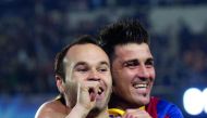 Barcelona’s Iniesta celebrates with team-mate David Villa after scoring a goal in this file photo.
