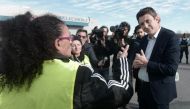 French Government's spokesperson Benjamin Griveaux (R) speaks with yellow vests (gilets jaunes) protestors before an official visit of Copelectronic, a company specialised in electronic and electric components, in Mouguerre, southwestern France, on Novemb