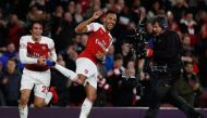 Arsenal's Gabonese striker Pierre-Emerick Aubameyang (R) celebrates with Arsenal's French midfielder Matteo Guendouzi (L) after the English Premier League football match between Arsenal and Tottenham Hotspur at the Emirates Stadium in London on December 2