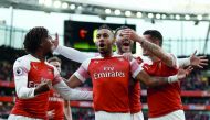 Arsenal's Gabonese striker Pierre-Emerick Aubameyang (C) celebrates after scoring the opening goal from the penalty spot during the English Premier League football match between Arsenal and Tottenham Hotspur at the Emirates Stadium in London on December 2